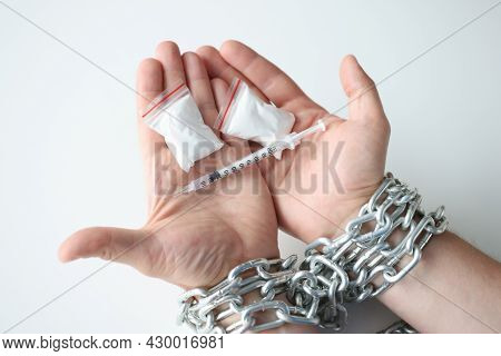 Man Tied Hands In Chain Holds Apackage Of Drugs