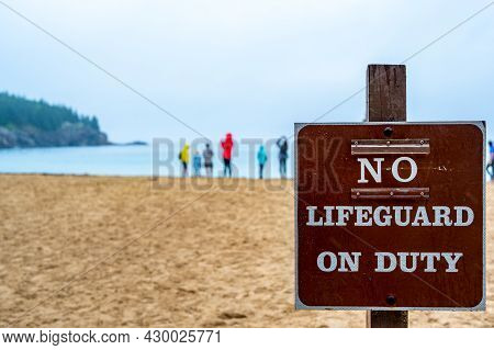 Posted Sign At A Sand Beach Stating No Lifeguard On Duty