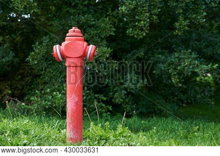 Red Fire Hydrant In City Park, Close Up. Preventive Measures Against Urban Fires