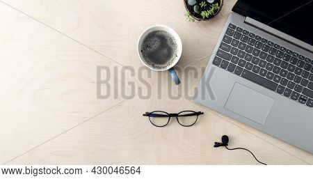 Working Business Space. Online Education, Training. Laptop, Coffee, Microphone On A Wooden Table, To