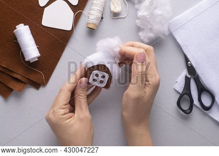 Filling The Felt Christmas Gingerbread House With Holofiber. Step-by-step Manufacturing Instructions