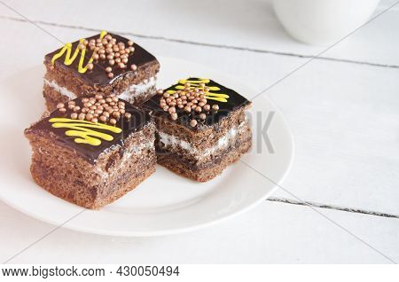 Three Chocolate Pies On A White, Wooden Table. Tea Party With Chocolod Cake. A Mug Of Tea, Cinnamon 