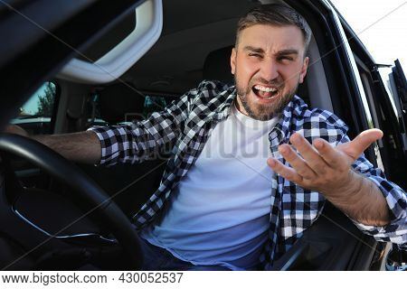Emotional Man In Car. Aggressive Driving Behavior
