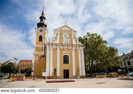 Hodonin, South Moravia, Czech Republic, 03 July 2021: Baroque White And Yellow Church Of St. Lawrenc