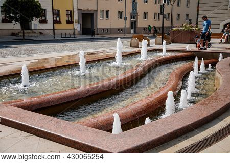 Hodonin, South Moravia, Czech Republic, 03 July 2021: Fountain Near Town Hall With Tower In Style Of