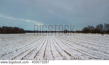 Aerial View Of A Rural Landscape, Farmfield Covered In Snow, Belgium From Above Taken With A Drone. 