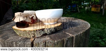 Two Jars Of Jam, Cup Of Tea From The Berries Of Viburnum, Lemon And Honey, On Background Of Wooden T