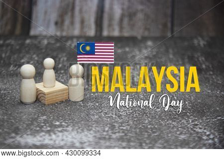 'malaysia National Day' Word With Wooden Dolls And Malaysia Mini Flag.