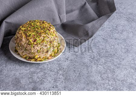 Sesame Halva With Pistachios Nuts On Gray Background With Gray Linen Napkin On Side And Copy Space. 