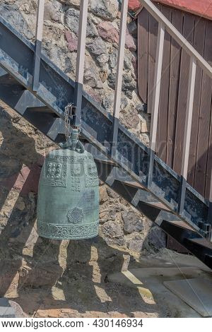 Seosan, South Korea; August 4, 2021: Small Temple Bell Hanging From Railing Of Medal Steps At Buddhi
