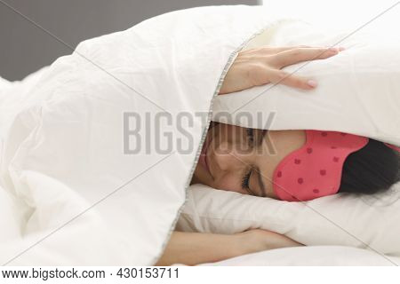 Woman Lies In Bed Covering Head With Blanket Closeup