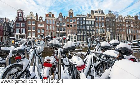 City scenic from a snowy Amsterdam in winter in the Netherlands