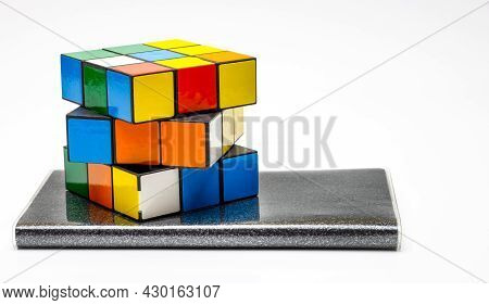 Dhaka, Bangladesh - 18 August 2021: Rubik Puzzle Unsolved Cube On A Notebook With White Copy Space