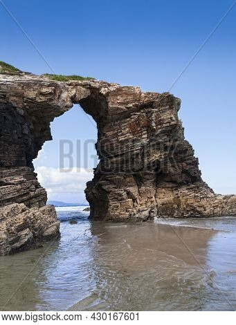 Arch-shaped Rock Formation On Las Catedrales Beach In Galicia In Spain.