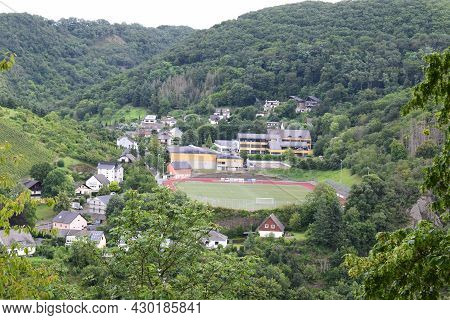 Treis-karden, Germany - August 6th 2021: Town Part Treis With School And Soccer Field On The Hill