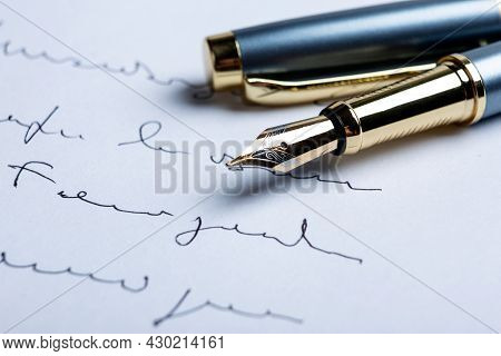 Fountain Pen On Paper With Ink Text On The Paper Closeup