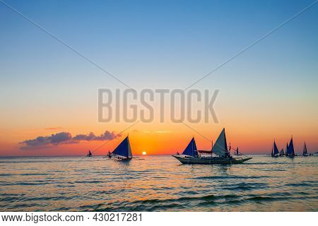 Traditional Filipino Boat At The Idyllic White Sand Beach At Boracay Island In Philiphines At Sunset