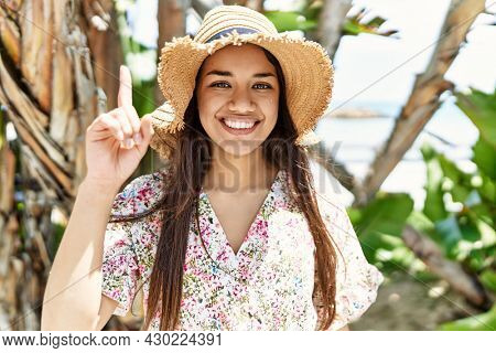 Young brunette woman outdoors on a sunny day of summer thinking attitude and sober expression looking self confident 