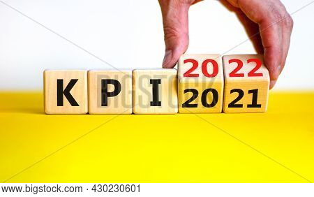 Kpi, Key Performance Indicator Symbol. Businessman Turns Wooden Cubes With Words 'kpi 2021' And 'kpi