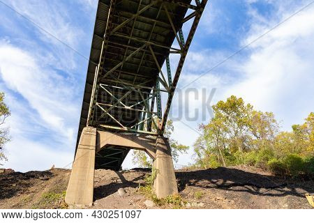 View Of The Underside Of A Bridge With Peeling Paint, Heavy Rust, Deteriorating Infrastructure, Hori
