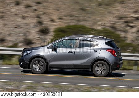 Novosibirsk, Russia - August 08, 2021:   
Silver Opel Mokka Driving Fast On Freeway In Highlands On 
