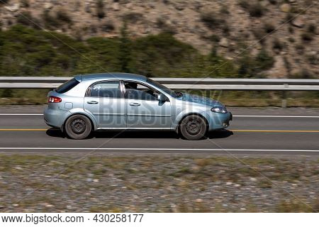 Novosibirsk, Russia - August 08, 2021:   
Blue Chevrolet Lacetti   Driving Fast On Freeway In Highla