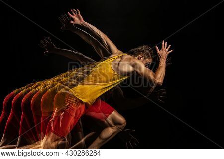 Portrait Of Young Man, Professional Male Athlete, Runner In Motion And Action Isolated On Dark Backg