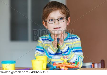 Smiling Preschool Kid Boy Having Fun With Dough, Colorful Modeling Compound Clay. Creative Leisure W