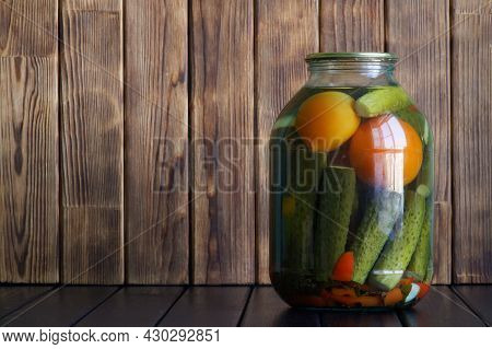 Large Three-liter Jar With Canned Cucumbers And Tomatoes On A Wooden Background From Pine Boards. Th