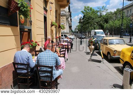 Budapest, Hungary - June 19, 2014: People Sit At Restaurant By Andrassy Avenue In Budapest. 3.3 Mill