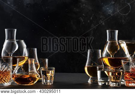 Strong Alcohol Drinks, Hard Liquors, Spirits And Distillates Iset In Glasses: Cognac, Scotch, Whiske