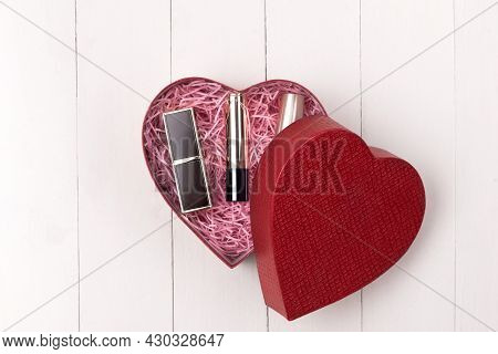 Makeup Cosmetics In Heart Shape Box On Wooden Table. Fflat Lay. Top View