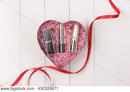 Makeup Cosmetics In Heart Shape Box On Wooden Table. Fflat Lay. Top View