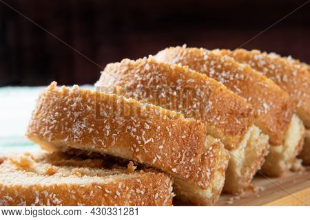 Rocambole, Sliced ​​rocambole Stuffed With Dulce De Leche On A Wooden Tray On A Table With Checkered