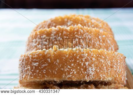 Rocambole, Sliced ​​rocambole Stuffed With Dulce De Leche On A Wooden Tray On A Table With Checkered