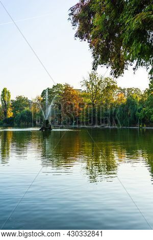 Vivid Green Landscape Near The Lake In Cismigiu Garden (gradina Cismigiu), A Public Park In The City
