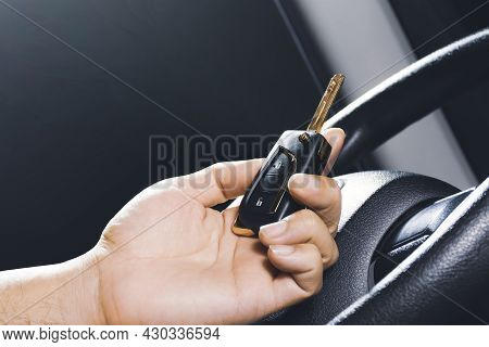 Car Keyless Entry Remote In The Owner Hand On The Car