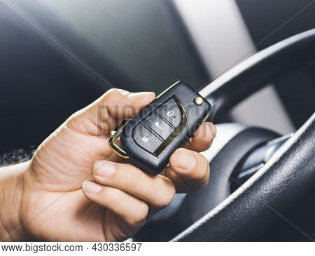 Car Keyless Entry Remote In The Owner Hand On The Car
