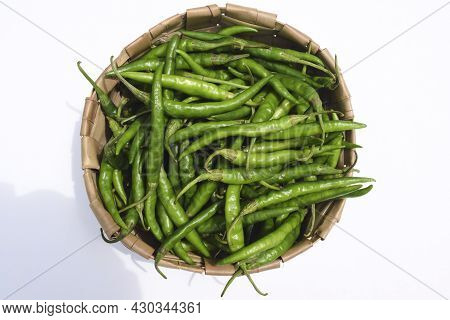 Freshly Plucked Spicy Hot Dark Green Chillies In Basket. Organic Green Peppers Harvest In Wicker Bas