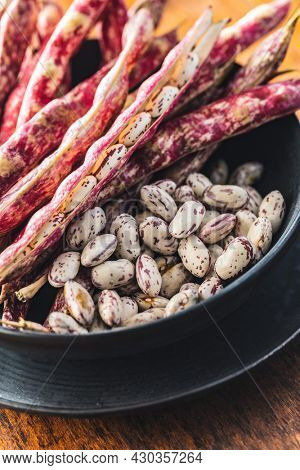 Cranberry beans. Borlotti beans in bowl. Beans pods