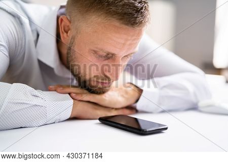 Man Waiting Phone Call At Office Desk