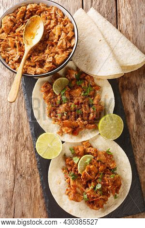 Sinaloan Pork In Chile Sauce Chilorio With Tortilla And Lime Closeup In The Slate Board On The Table