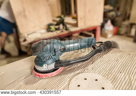 Electric Grinder Tool On The Workshop Table. Grinding Machine In Wood Industry. Woodwork Processing