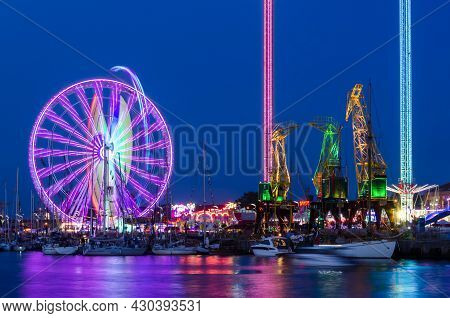 Szczecin, West Pomeranian - Poland - 2021: Amusement Park And Old Historic Harbor Cranes In The Area