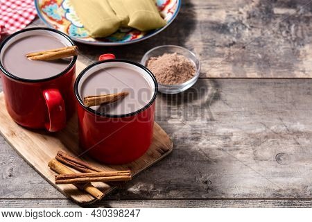 Traditional Mexican Chocolate Atole Drink On Wooden Table. Copy Space