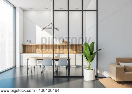Panoramic White Kitchen Interior With A Simplified Cabinet, Table, Frame Chandelier, Glass Partition