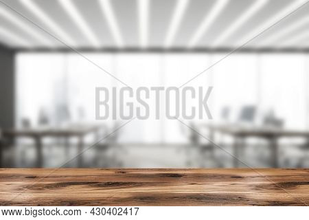 Wooden Table For Product Ad With Grey And White Panoramic Open Space Interior On The Blurred Backgro