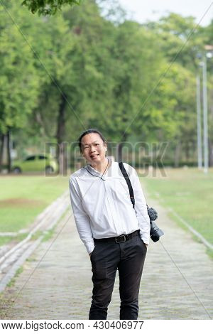 Asian Freelance Long Hair Man Standing And Posting On The Walk Way In The Garden Outdoor Field With 