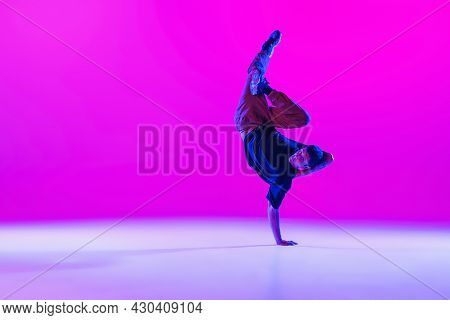 One Dancing Man, Break Dancer In Action, Motion In Modern Clothes Isolated Over Bright Magenta Backg