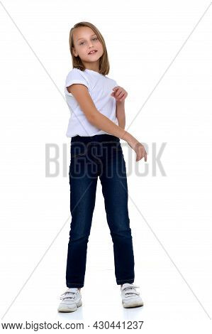 Blonde In A White T-shirt. Pretty Stylish Girl Posing In Studio On A White Background. Full-length P